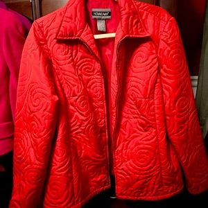 Coral colored suit jacket.